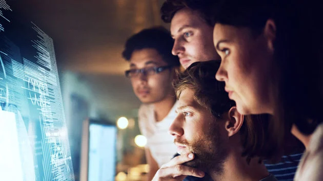 People looking at multiple screens